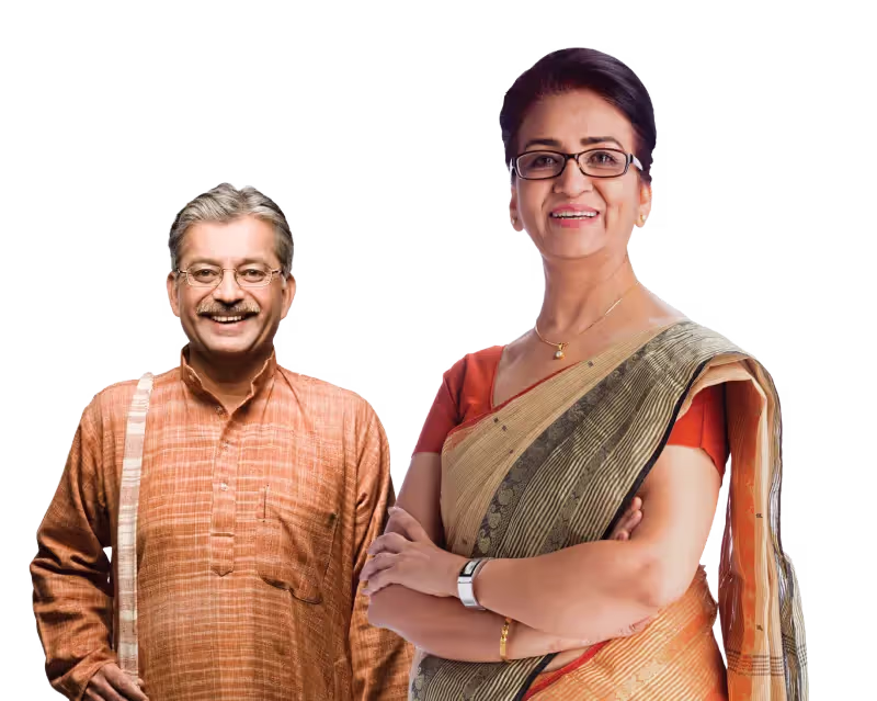 Smiling middle-aged Indian couple, man in traditional kurta and woman in saree with glasses and arms crossed.